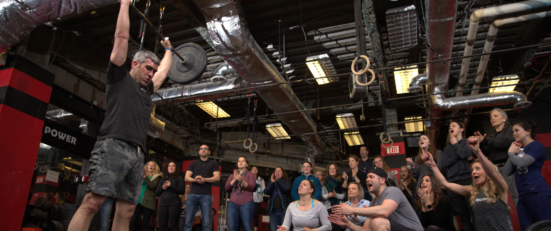 Launching Your CrossFit Gym In 2024 A Comprehensive Guide   Man Lifting Weights In Front Of Crowd 